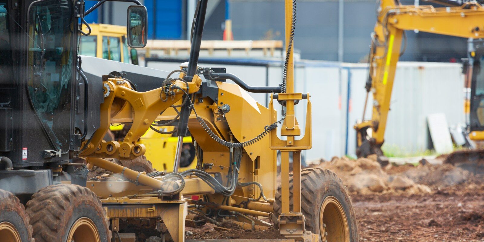 a yellow bulldozer is parked in the dirt