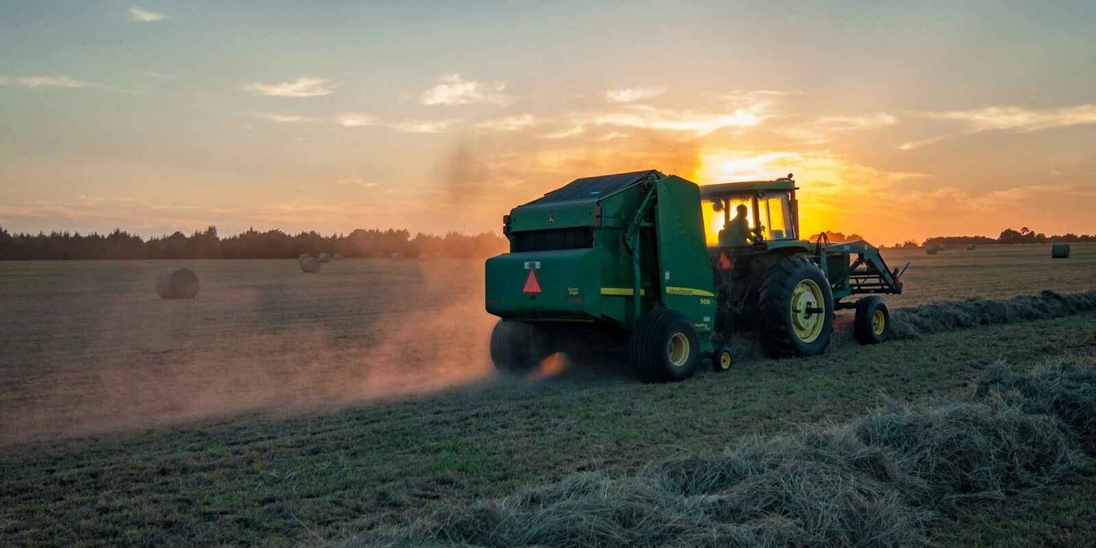green farm heavy equipment on green field