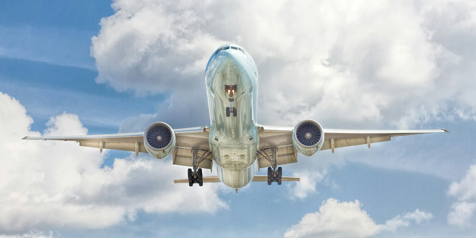 gray and white airplane on flight near clear blue sky